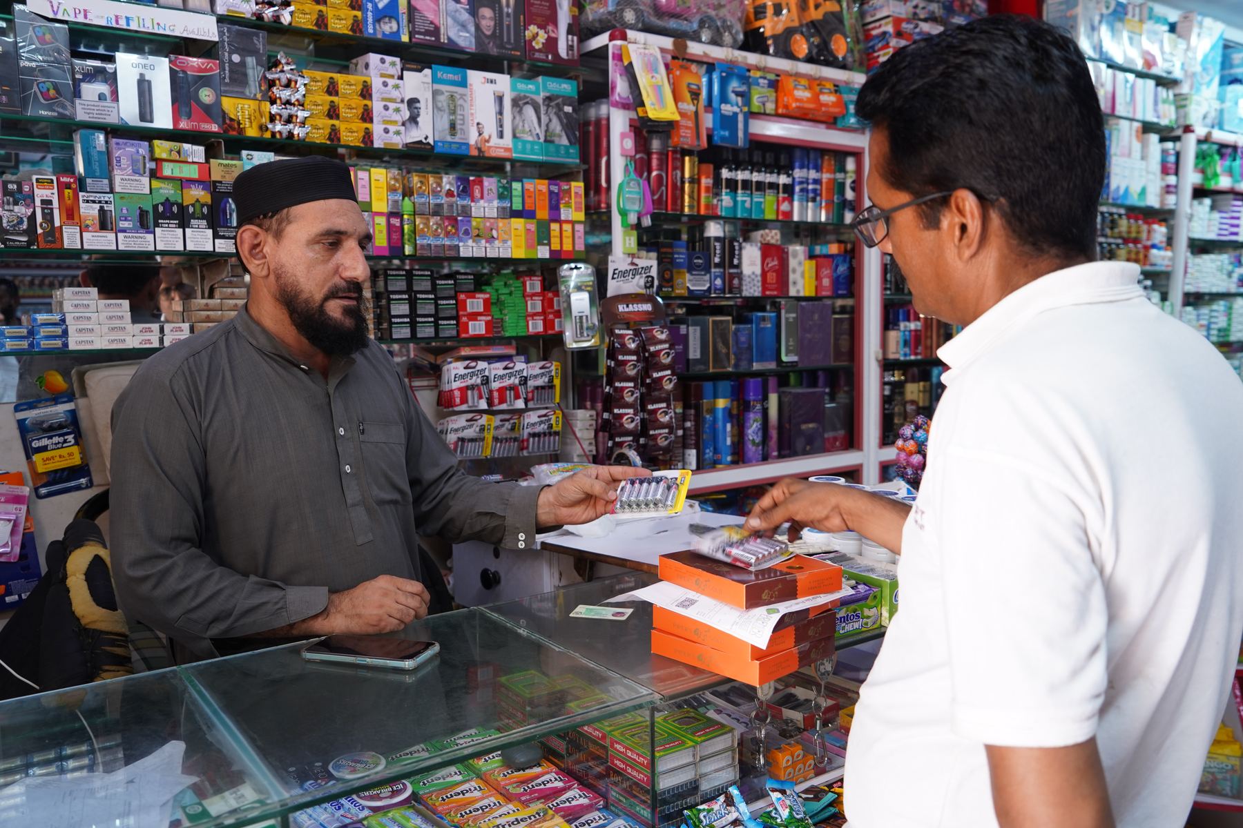 Tarseel sales rep with a general trade shopkeeper