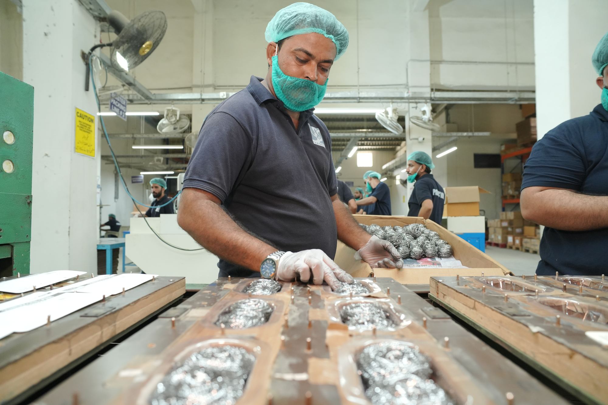 Operator on the spiral scourer line at the KIA production facility