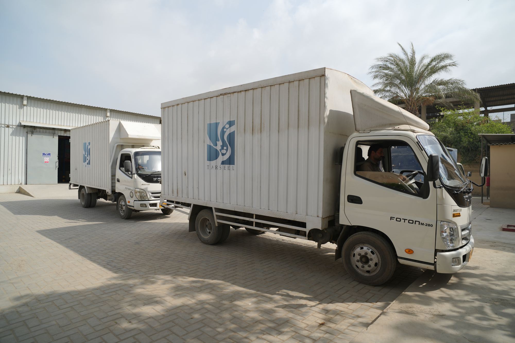 Tarseel-branded delivery trucks at the warehouse